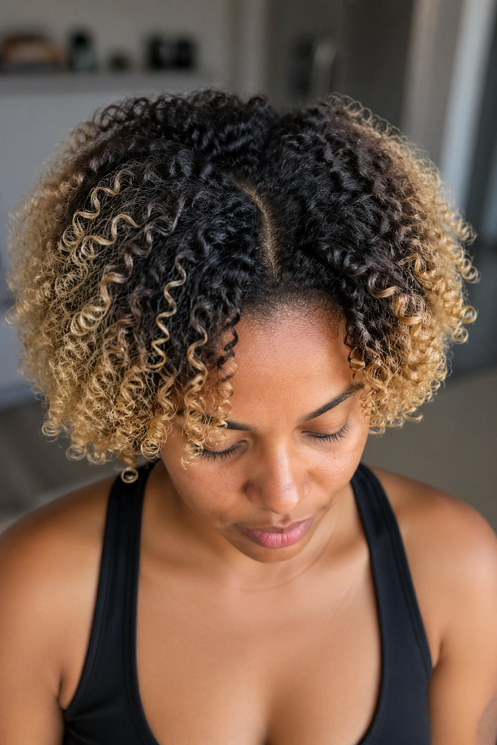Close-up of a real person's hair showing transition from dark roots to lighter ends