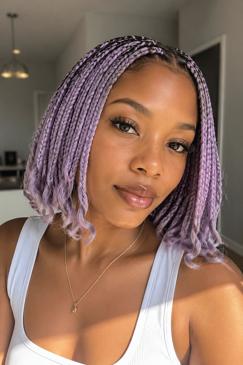 Close-up of lilac bob-length boho box braids framing the face