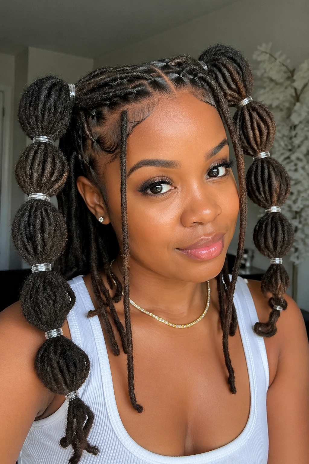 Front three-quarter view of a real person with bubble double ponytails and clear bands