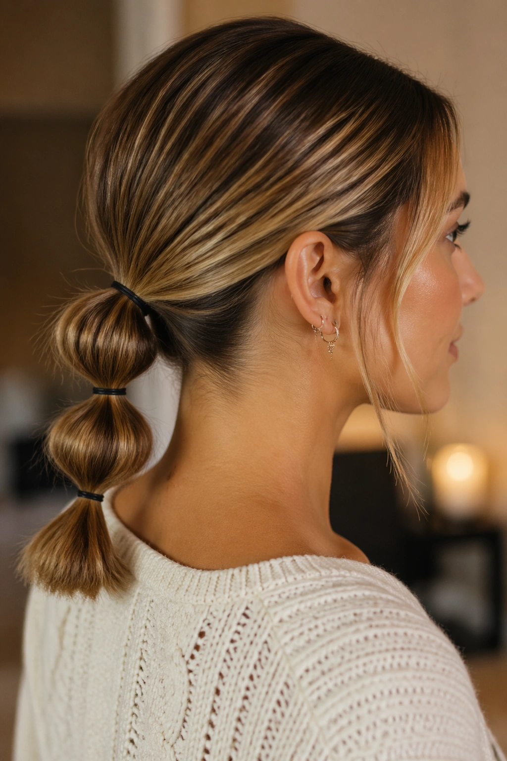 Close-up of a real woman wearing a low nape bubble ponytail on a bob hairstyle