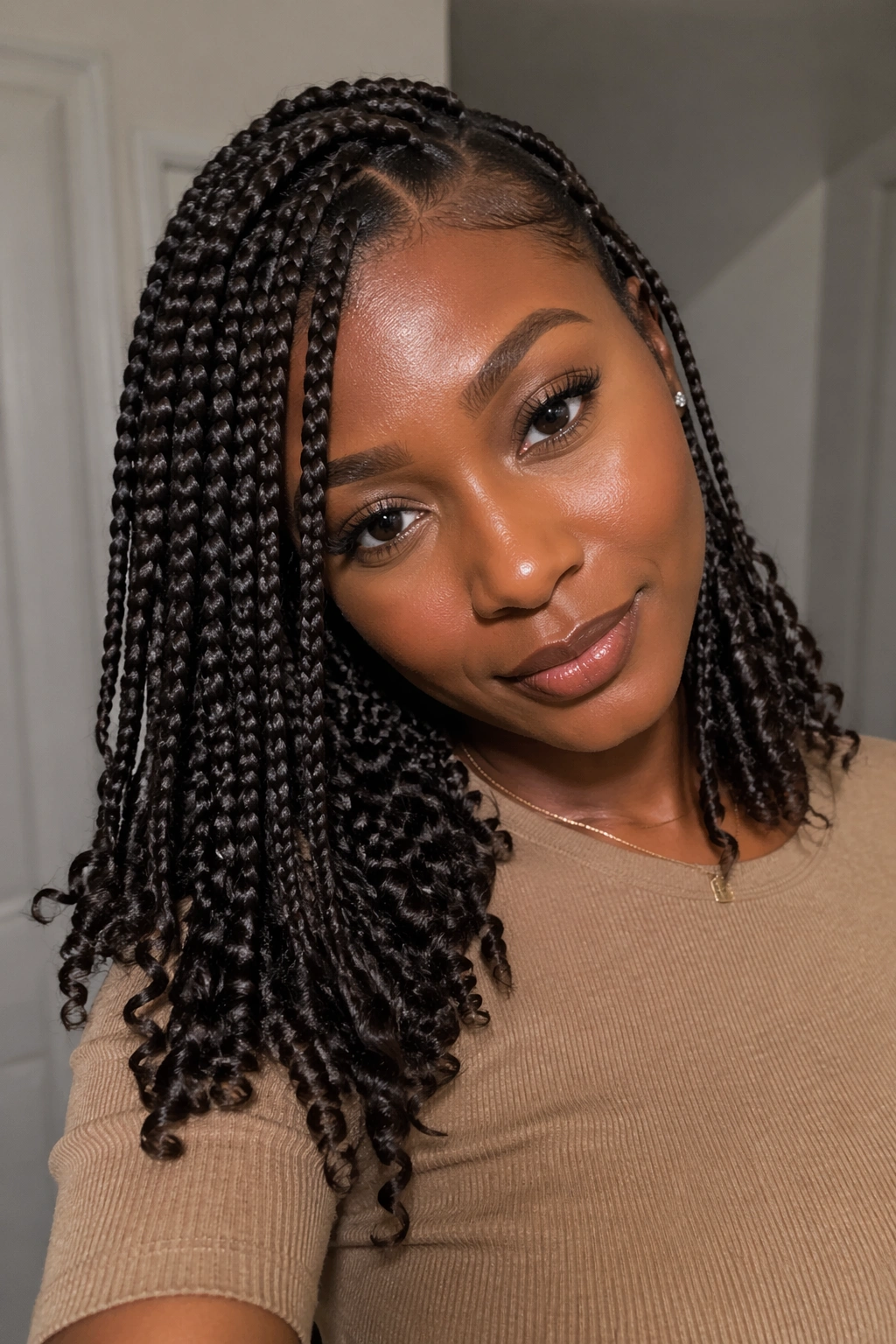 Medium box braids with a deep side part and curly ends on a real person