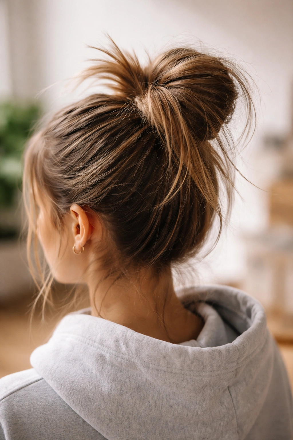 Close-up of a messy top-knot pony with ends sticking out