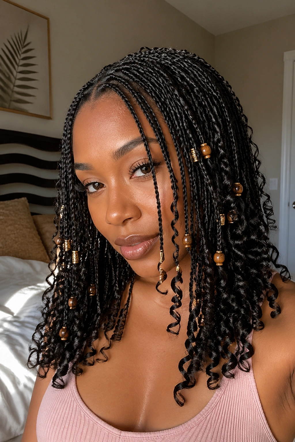 Close-up of a real woman with mini braids, curls, and beads.