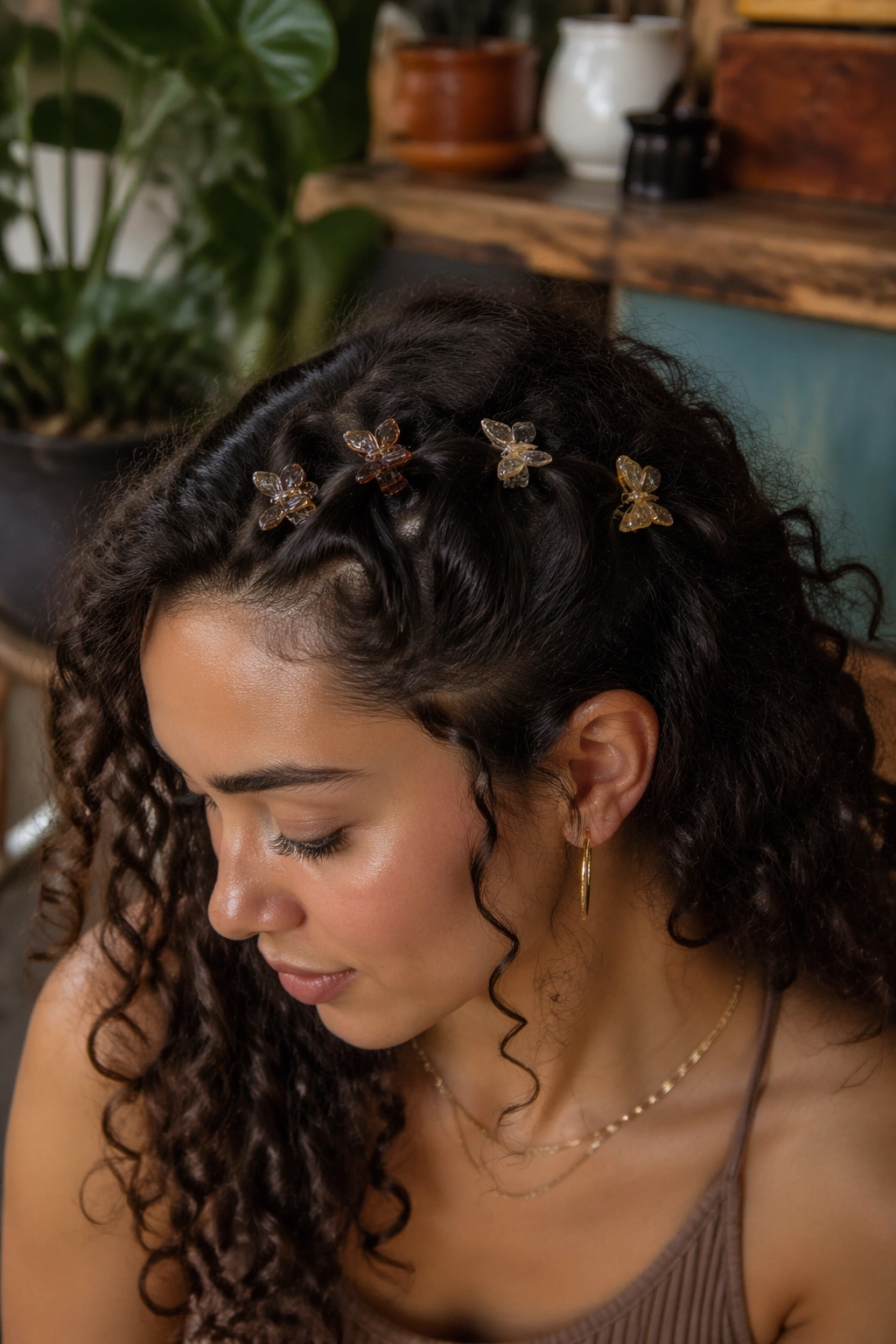 Portrait of a real woman with multiple mini butterfly clips arranged along the temple in a playful pattern.