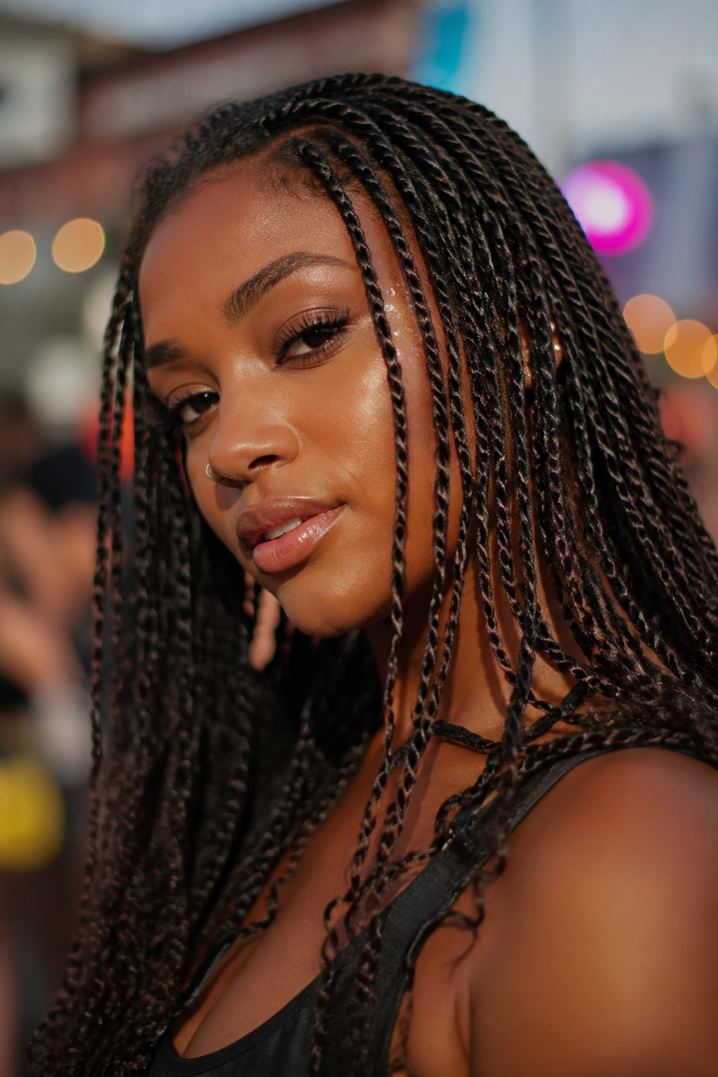 Close-up of a person with mini twists hairstyle at festival