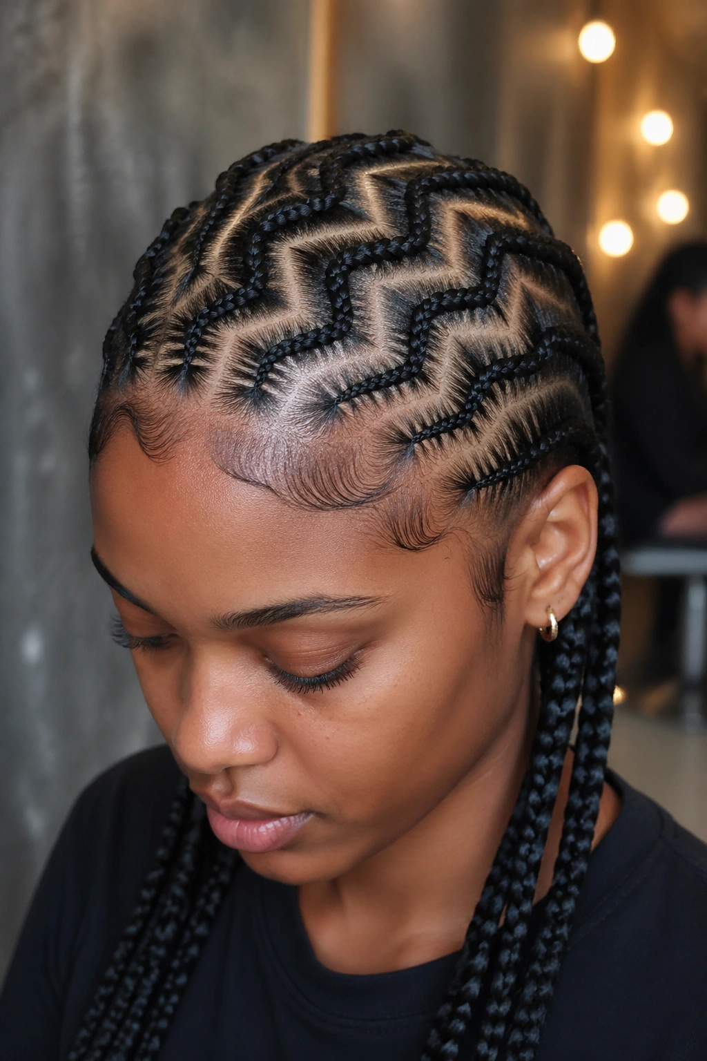 Close-up of mixed-width zigzag cornrows on a real woman's head.