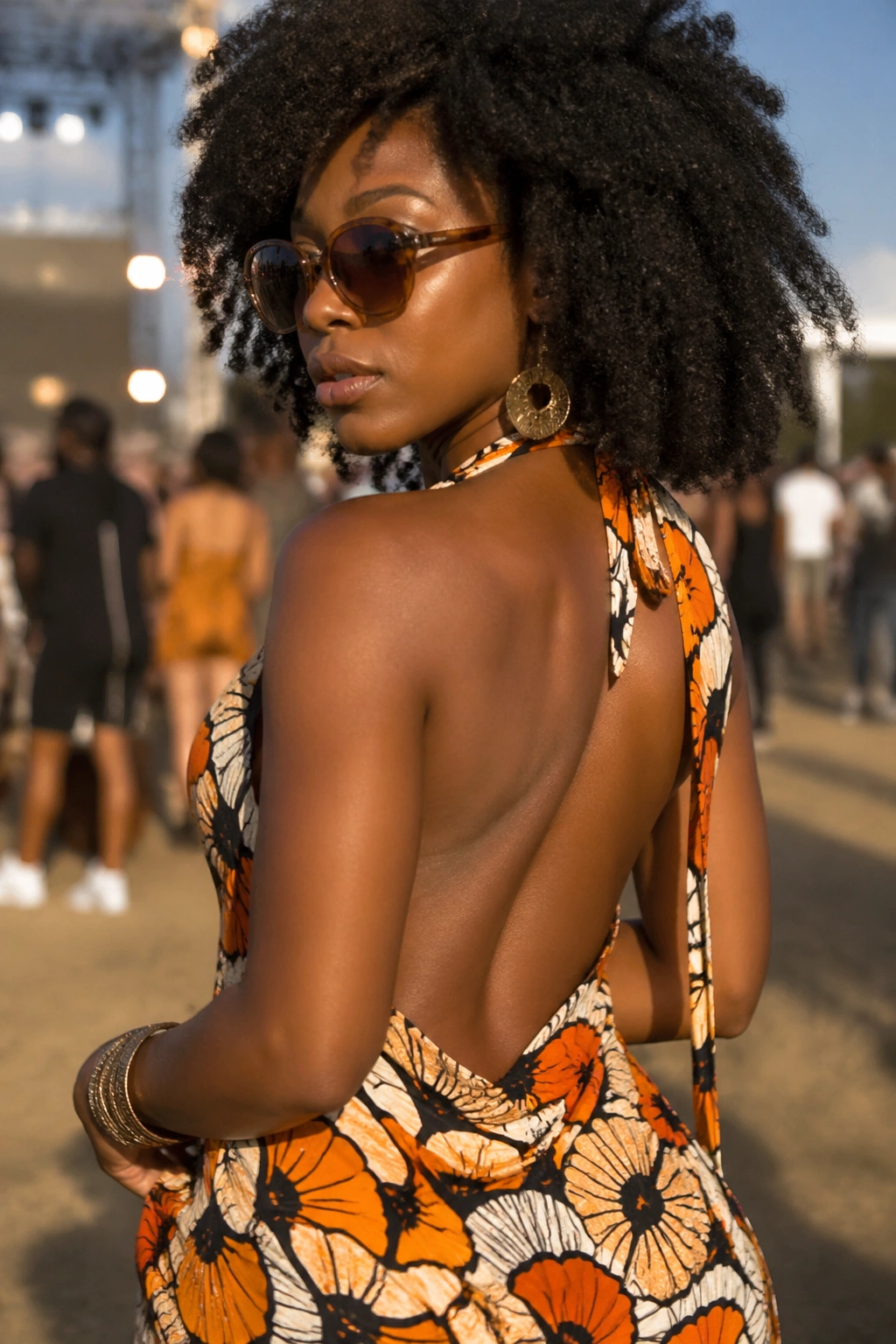 Close-up showing an open-back halter dress with bold print on a real person at a festival