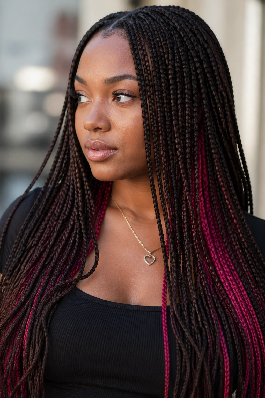 Dark brown braids with subtle pink peekaboo streaks.