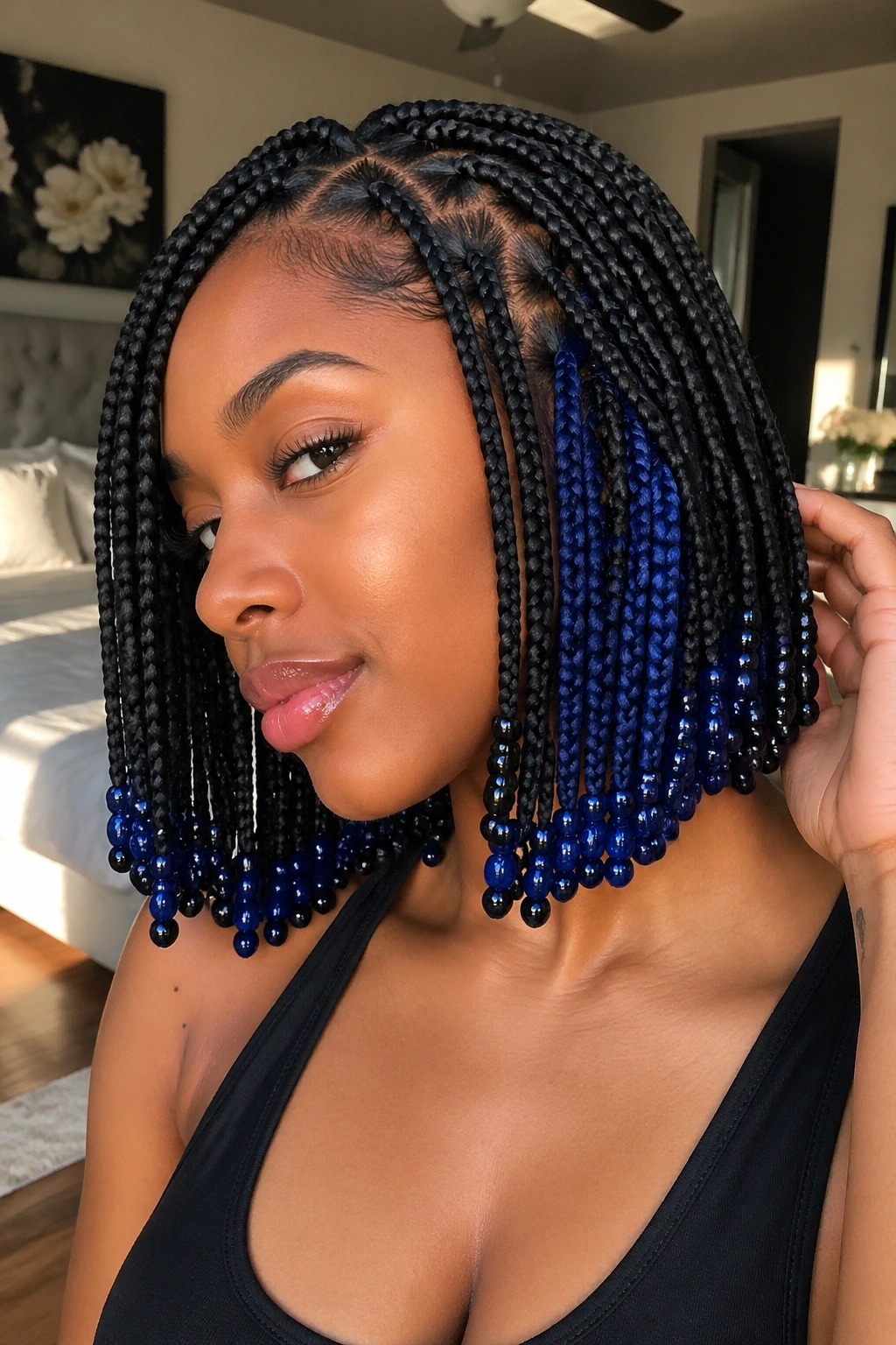 Close-up of a real woman with jet-black short box braids and sapphire peekaboo beads