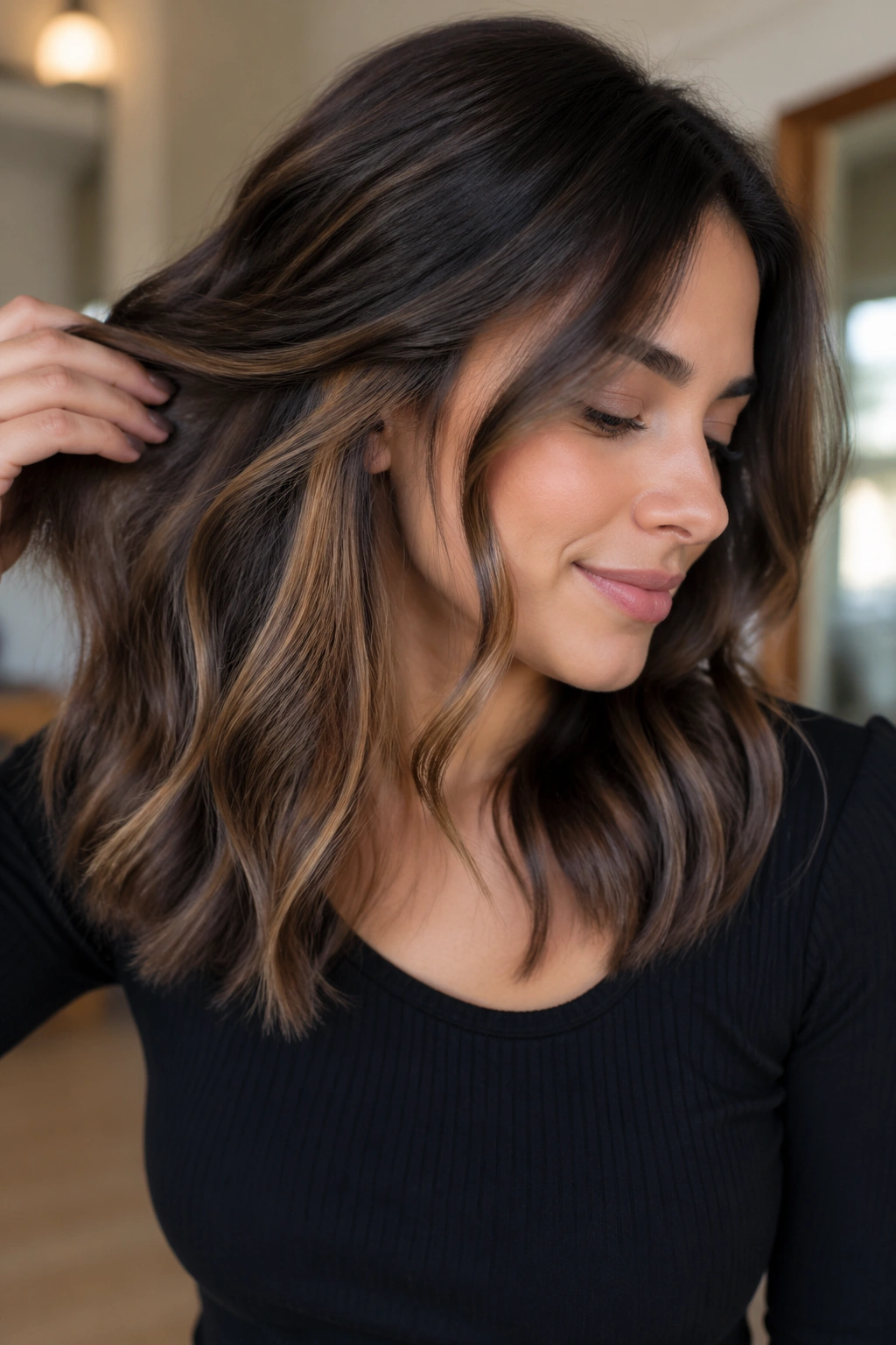 Close-up portrait of a person showing peekaboo highlights under the hair layer.