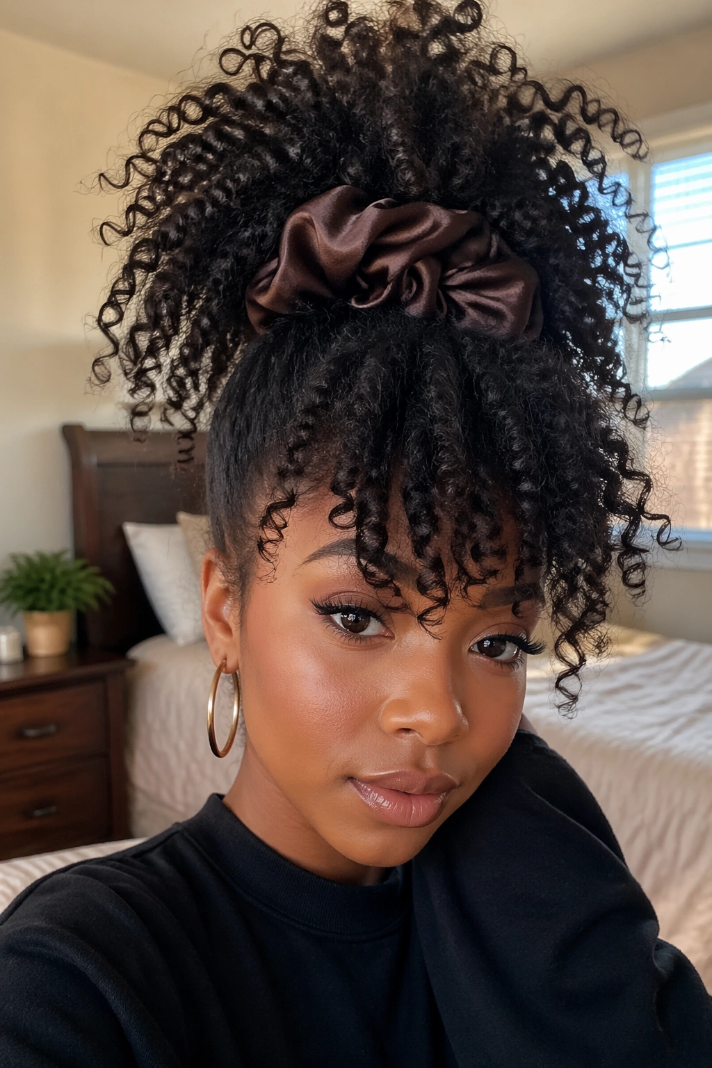 Close-up of a real person with a high pineapple updo and cascading volume