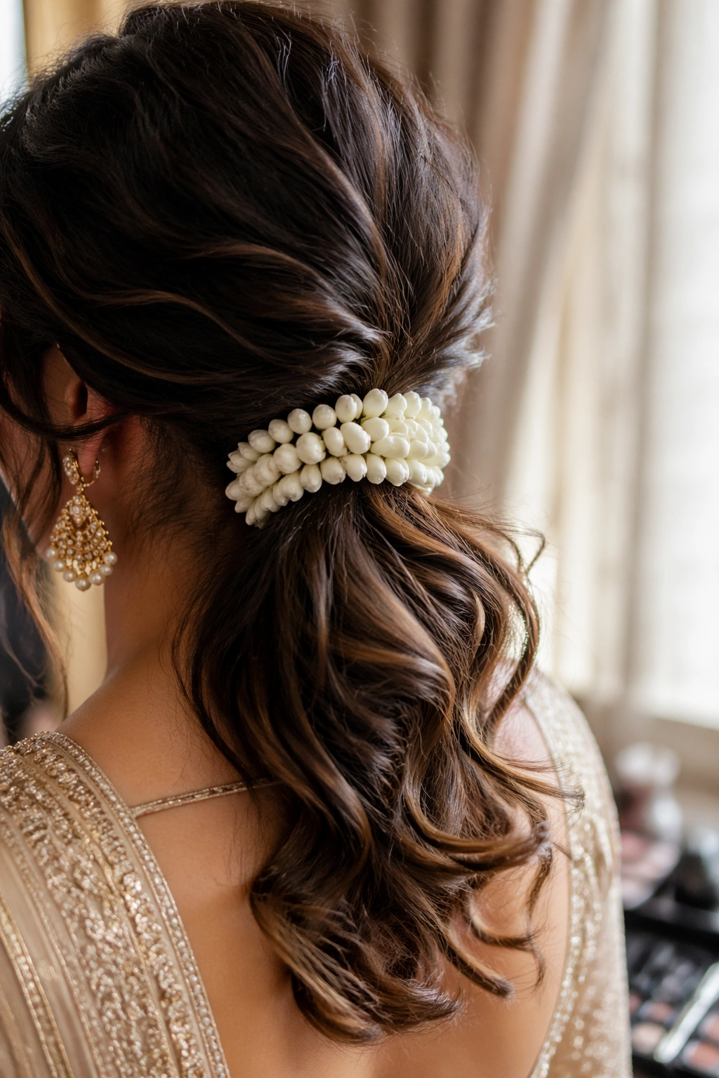 Close-up of low messy ponytail with jasmine gajra at nape