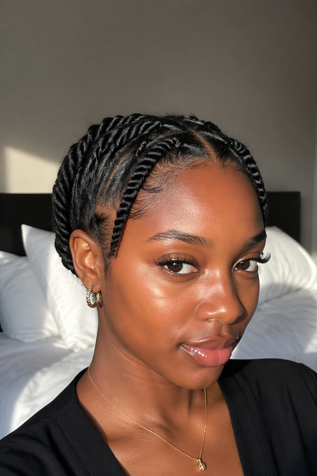 Close-up portrait of pulled-back natural hair with crown twists on real woman