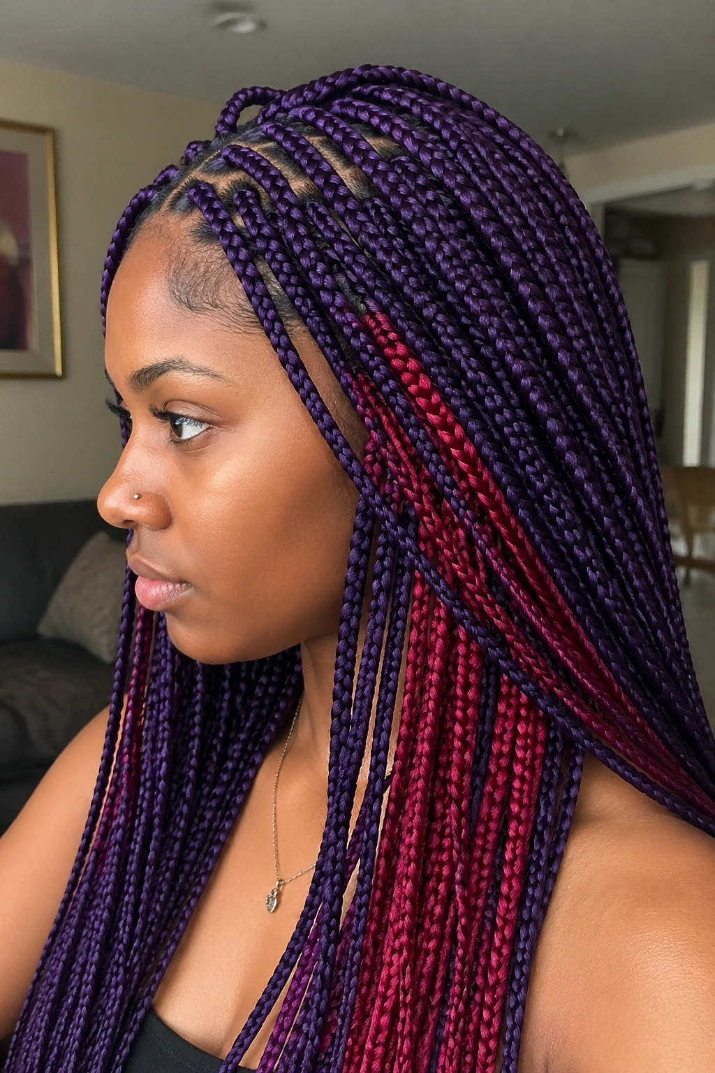 Close-up of a real person with purple braids and red peekaboo layers