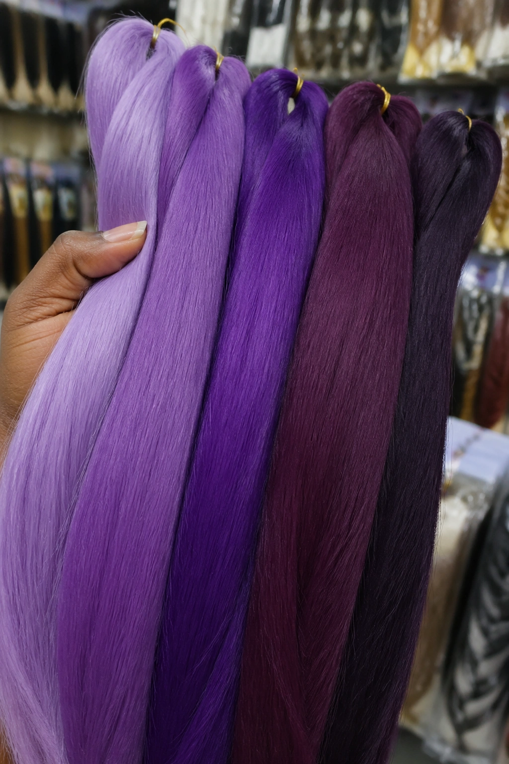 Close-up of purple kanekalon braiding hair bundles in a store setting