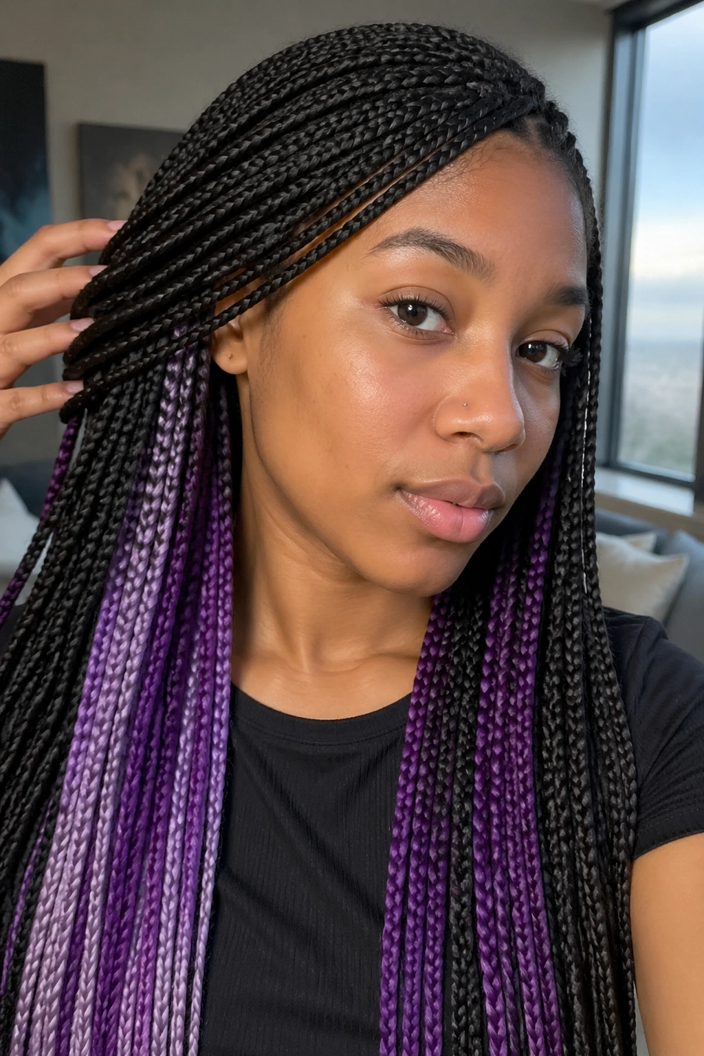 Close-up of purple peekaboo braids under a dark top layer on a real person