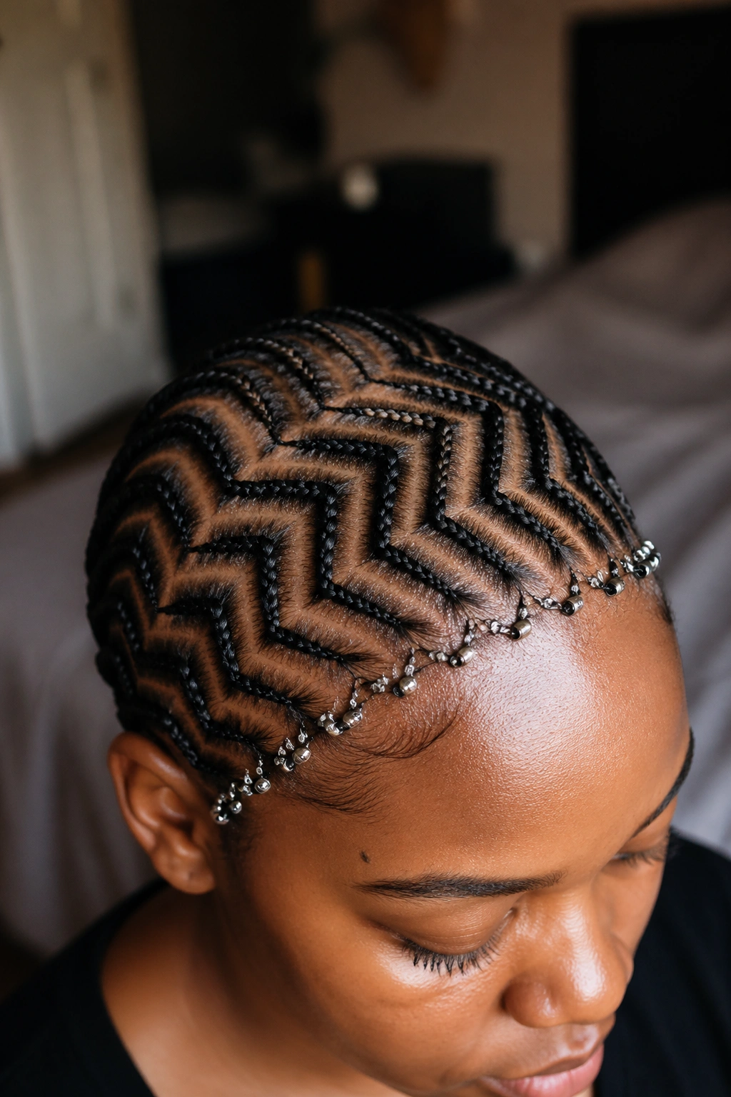 Close-up of a real person with reverse zig zag braids and a beaded halo around the front