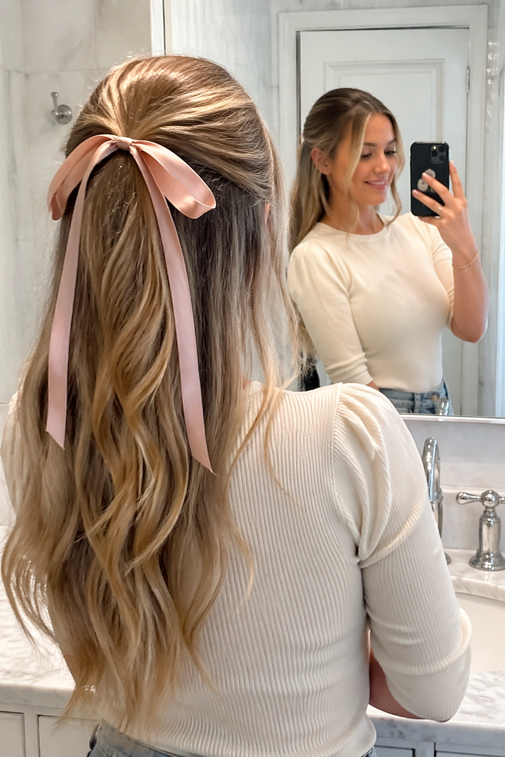 Over-the-shoulder mirror selfie of ribbon-tied half-up ponytail.