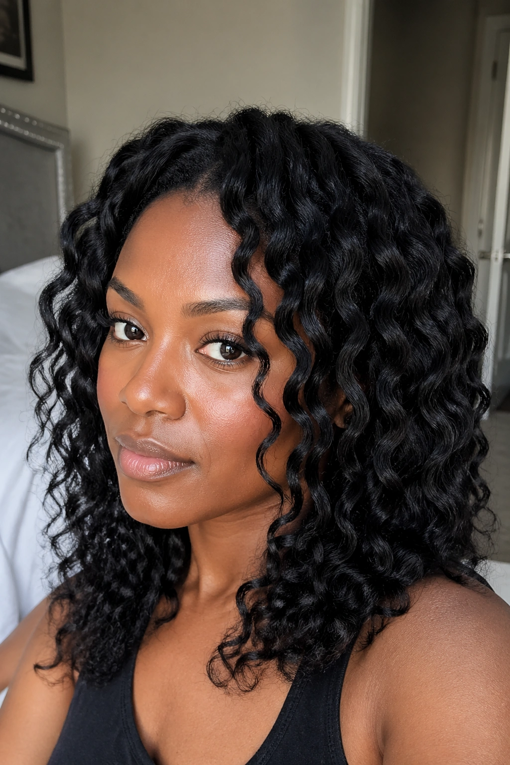 Close-up portrait of a real person with stretched S curl twist-out.
