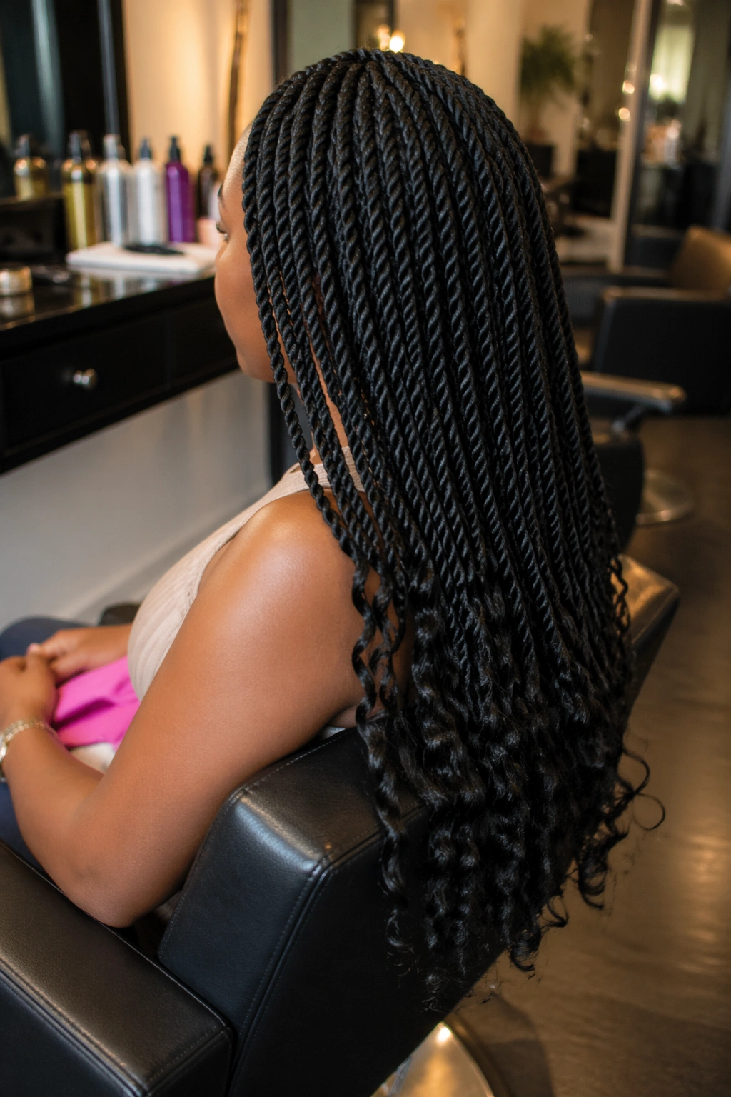 Senegalese twists with curly tips over-the-shoulder view in salon