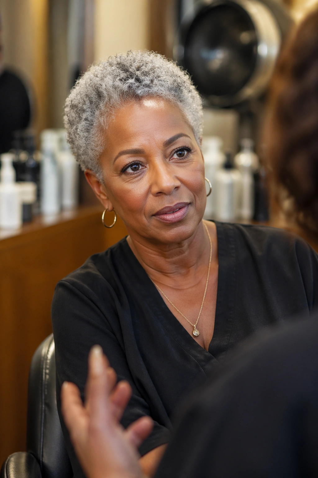 Portrait of a real woman with short grey natural curls in a salon setting