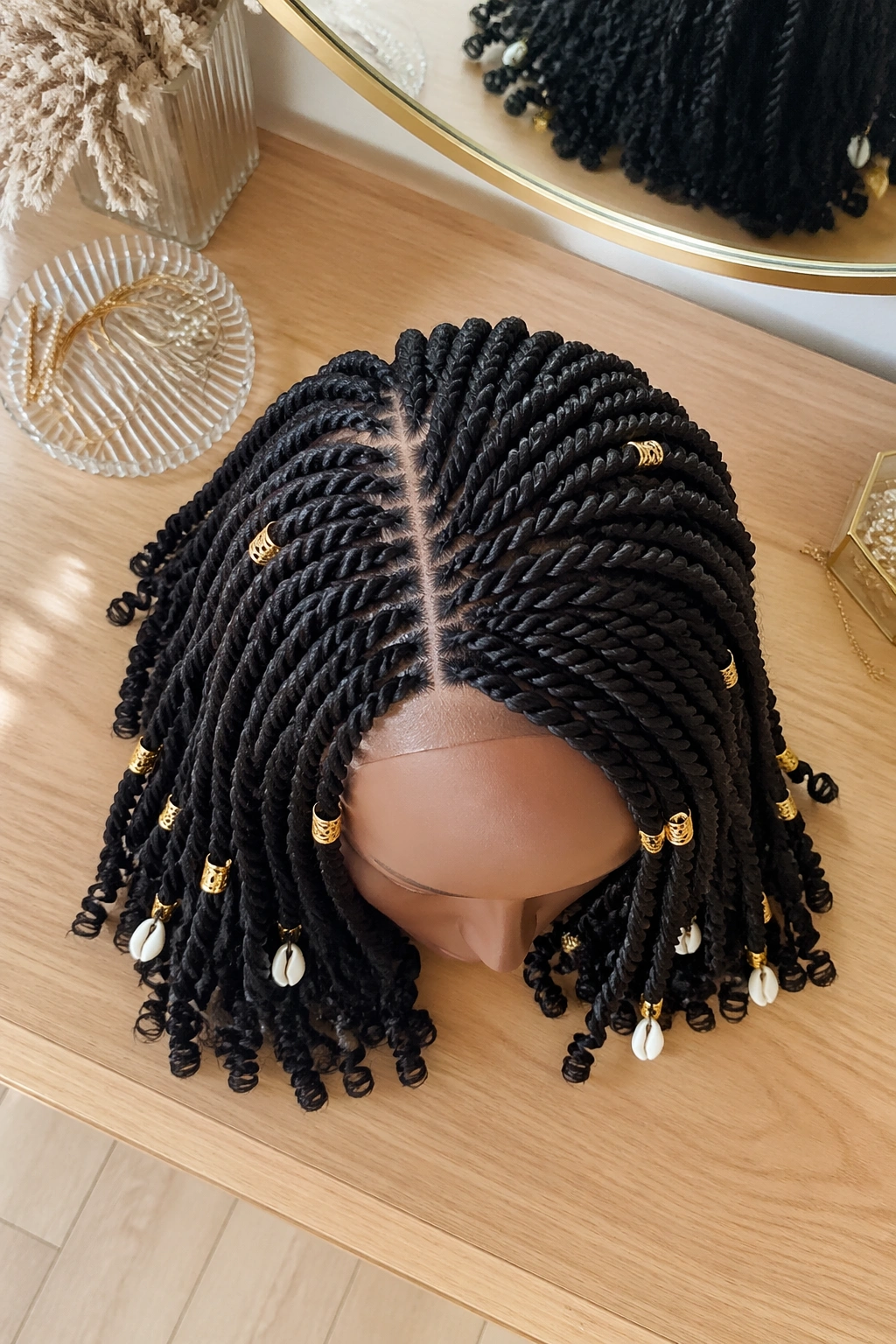 Overhead flat-lay of side-parted twists with cuffs