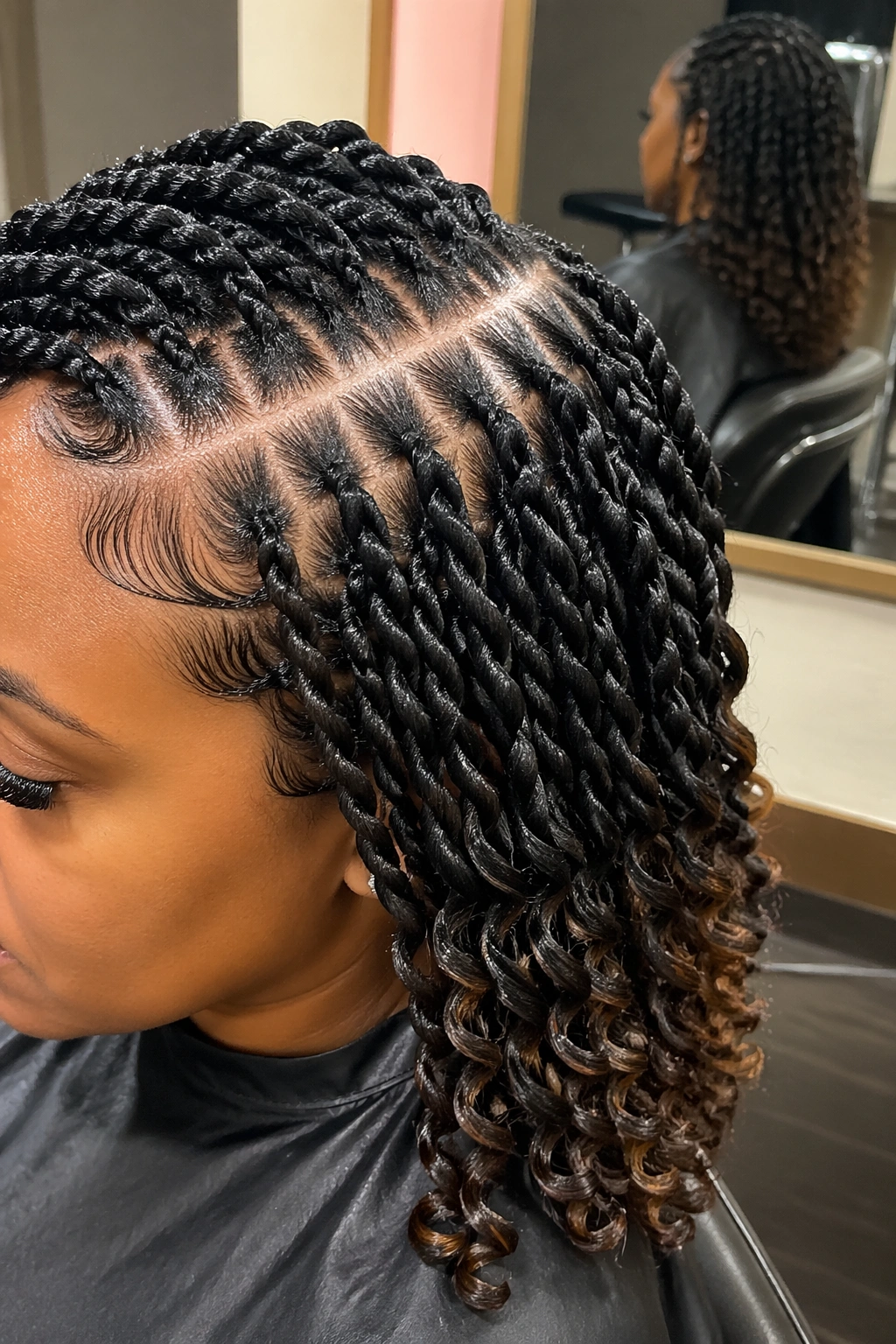 Close-up of side-part twist braids with clean edges and curly ends.