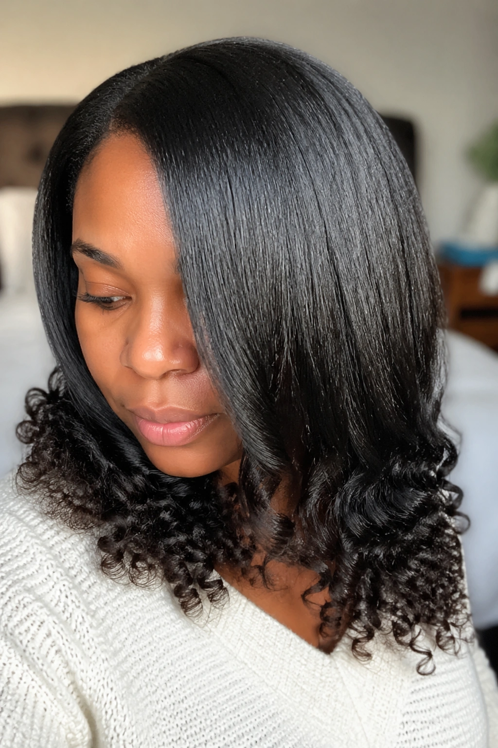 Close-up of silk press with tapered curl ends showing gradient from smooth to tight curls