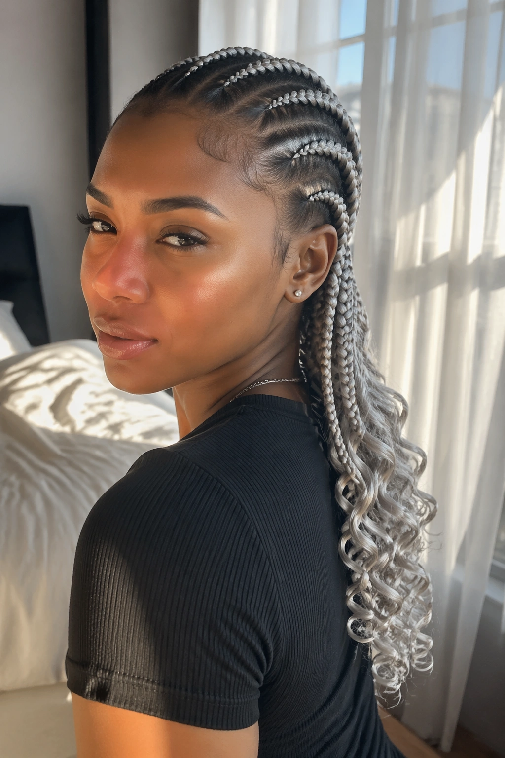 Close-up of real woman with silver cornrows ending in curls under soft window light