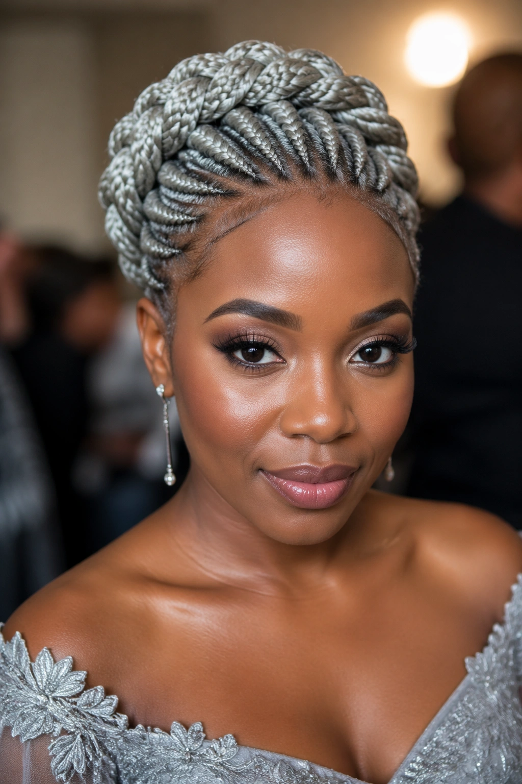 Portrait of silver cornrows arranged into a halo updo on a real person