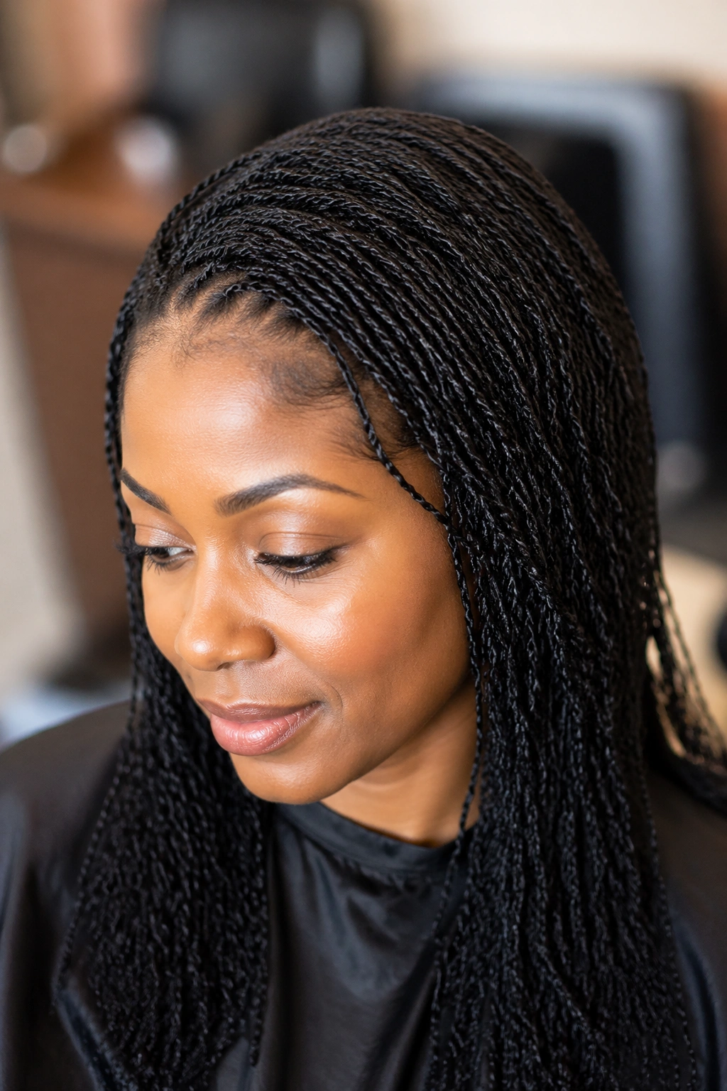 Close-up of a real woman's scalp with hundreds of ultra-fine perm twists in a Sisterlocks-inspired pattern