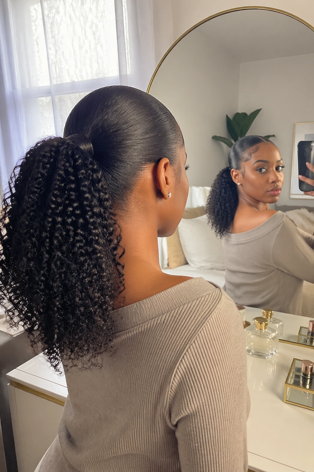 Over-the-shoulder view of sleek mid weave ponytail on short natural hair.