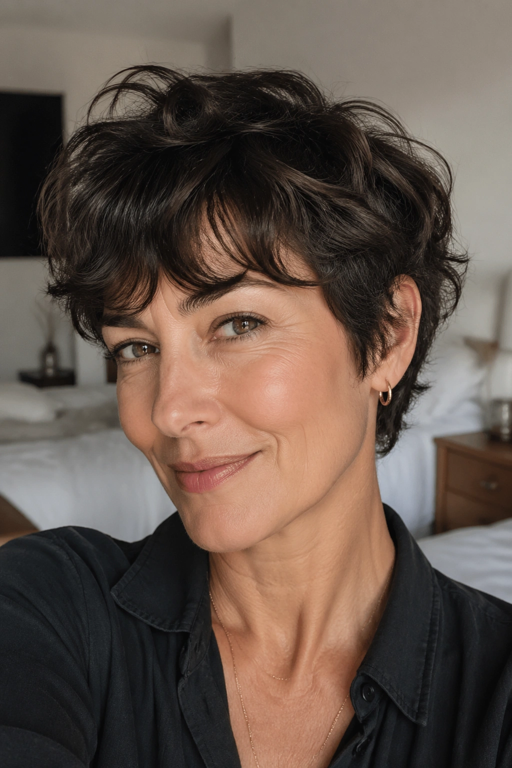 Real woman with soft shag pixie showing layered texture and lifted crown