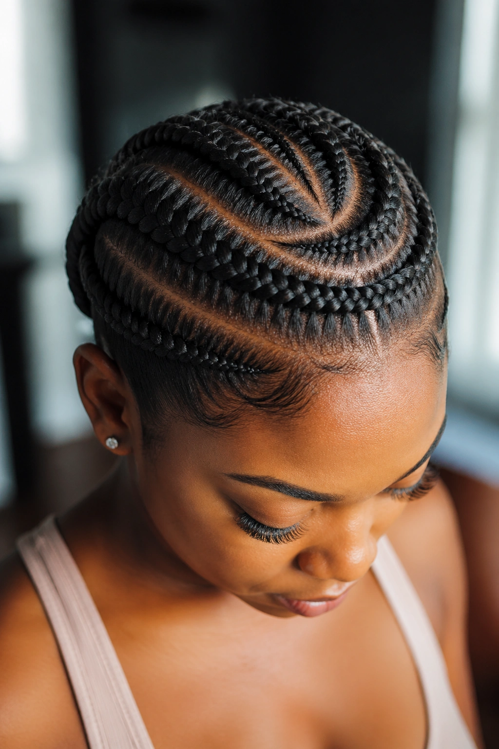Close-up of a real woman's head with a stitch braid halo around the crown