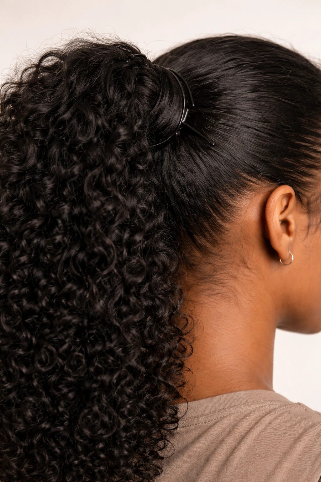 Tight bun base securing a ponytail with extension close-up