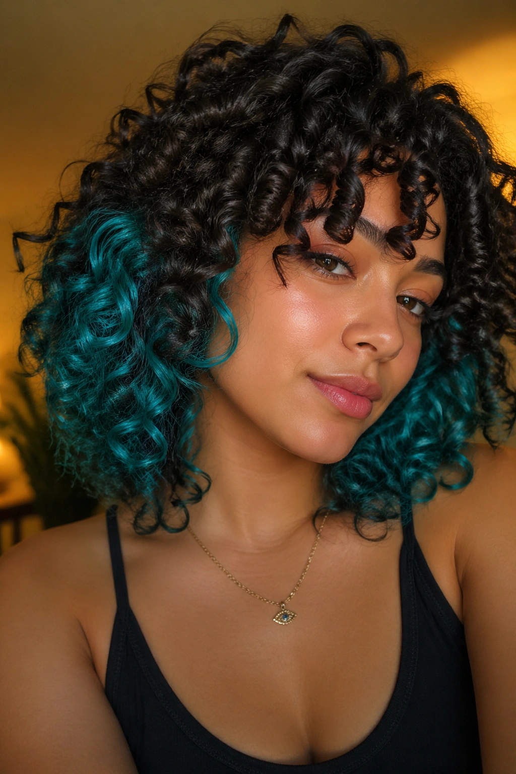 Close-up of a real person with teal and turquoise accent pieces in curly hair