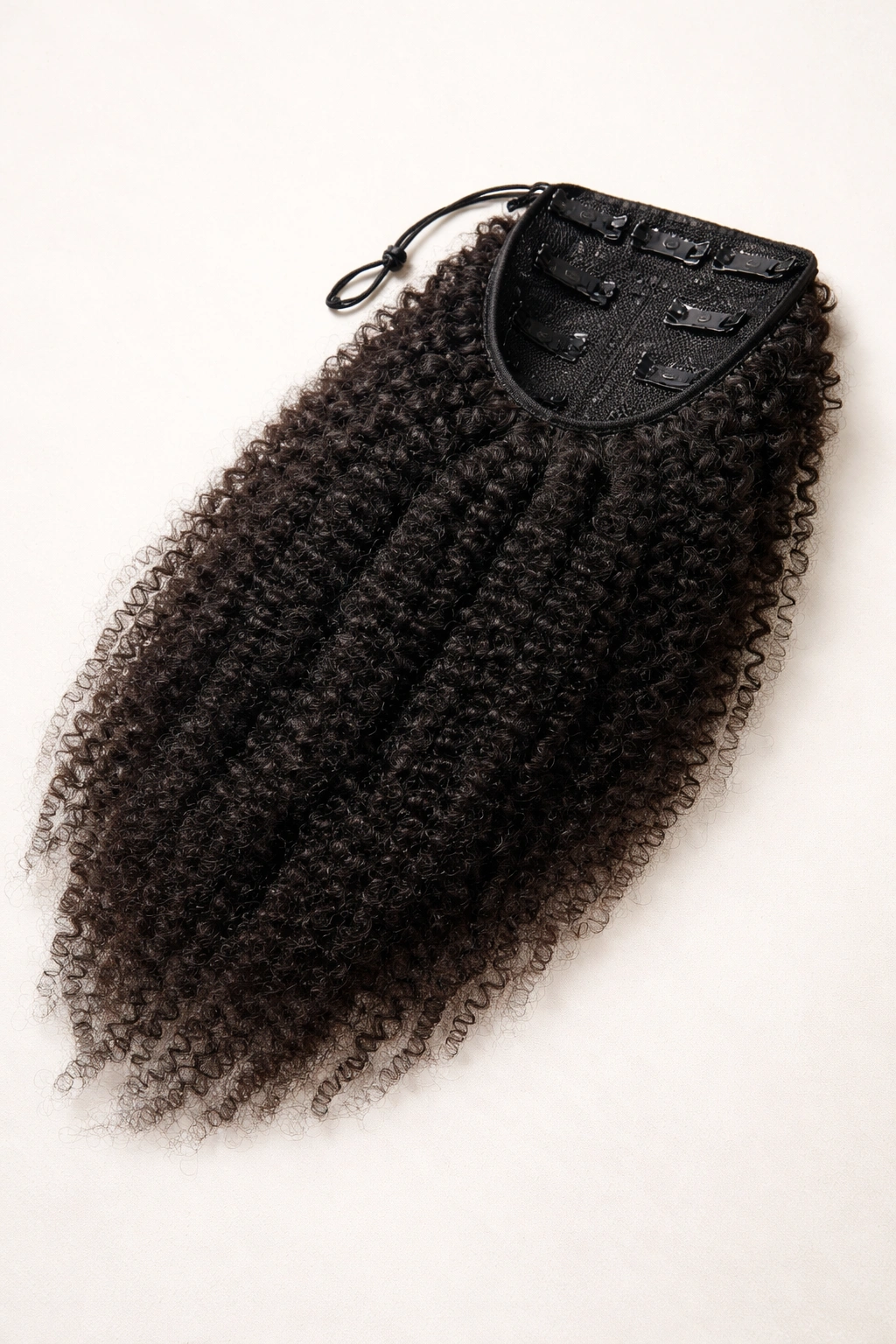 Texture-matched clip-in ponytail extension with visible clips on neutral background