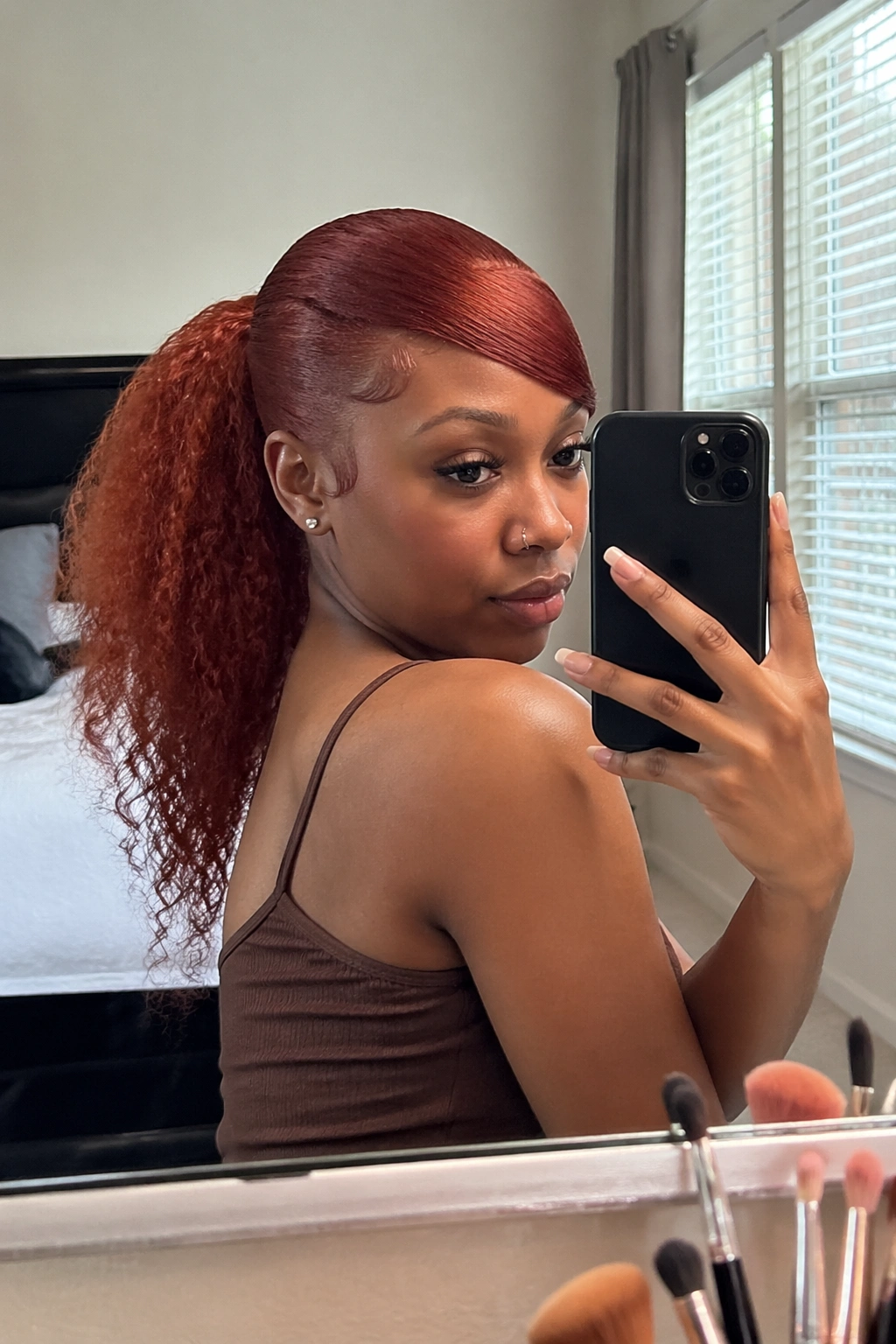 Over-the-shoulder mirror selfie of Auburn Textured Swoop Ponytail