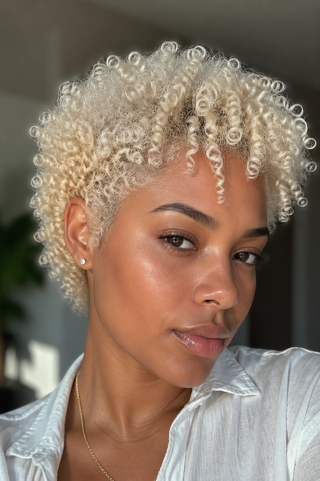 Close-up of cool-toned platinum blonde curls in soft natural light