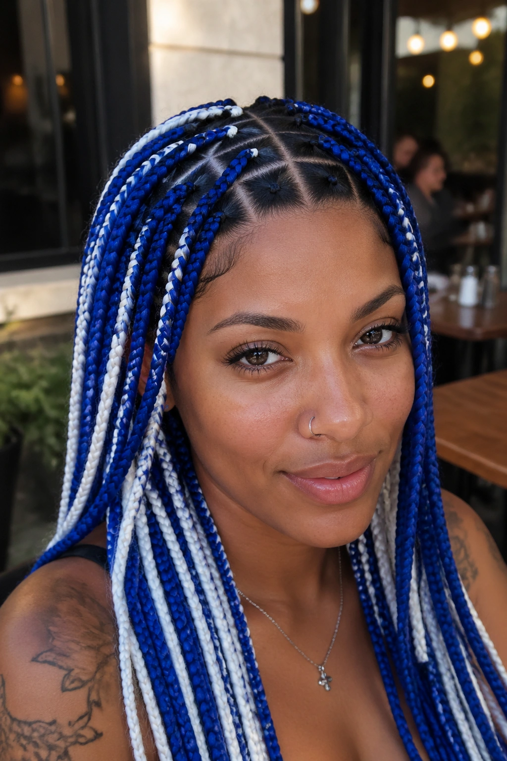 Real woman with triangle-part blue and white box braids