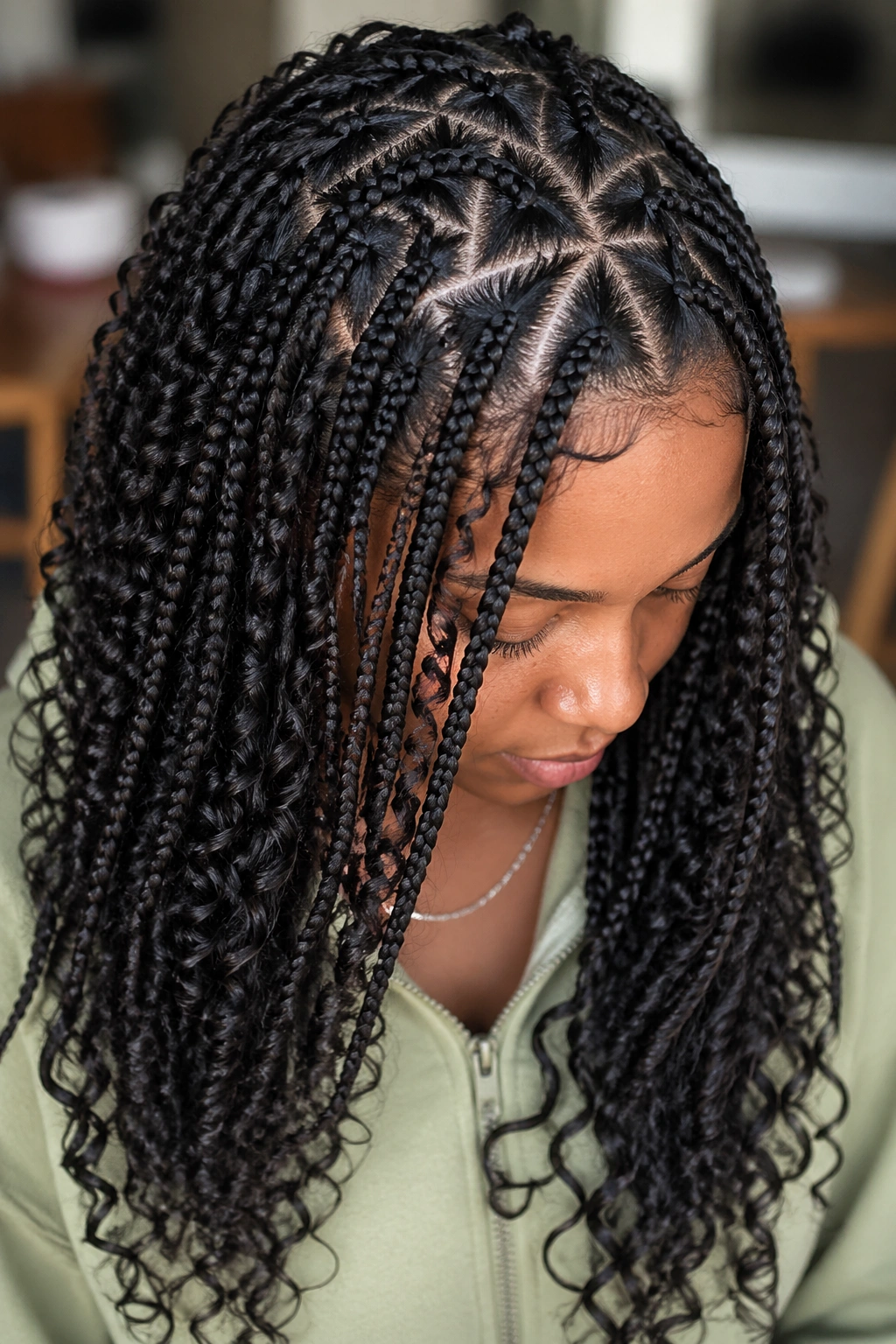 Close-up of triangle-part knotless braids with curls on a real person