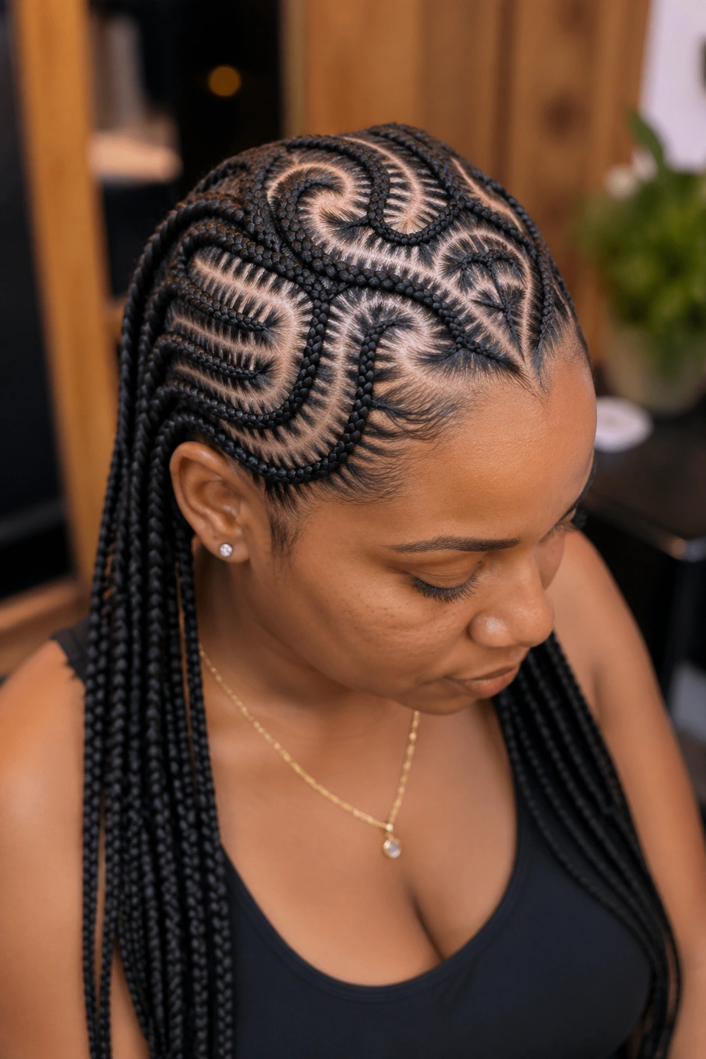 Close-up of tribal cornrows forming heart patterns at the crown