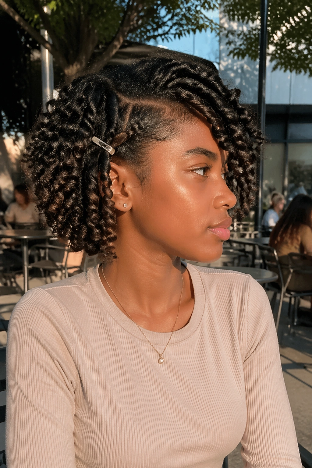 Twist-out bob with side-swept curls in profile