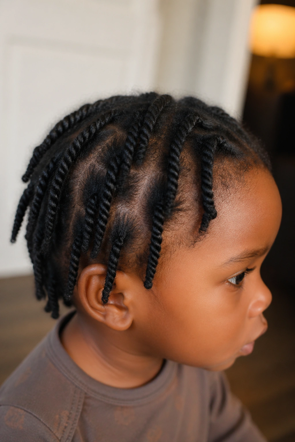 Close-up of a toddler with two-strand protective twists across the scalp
