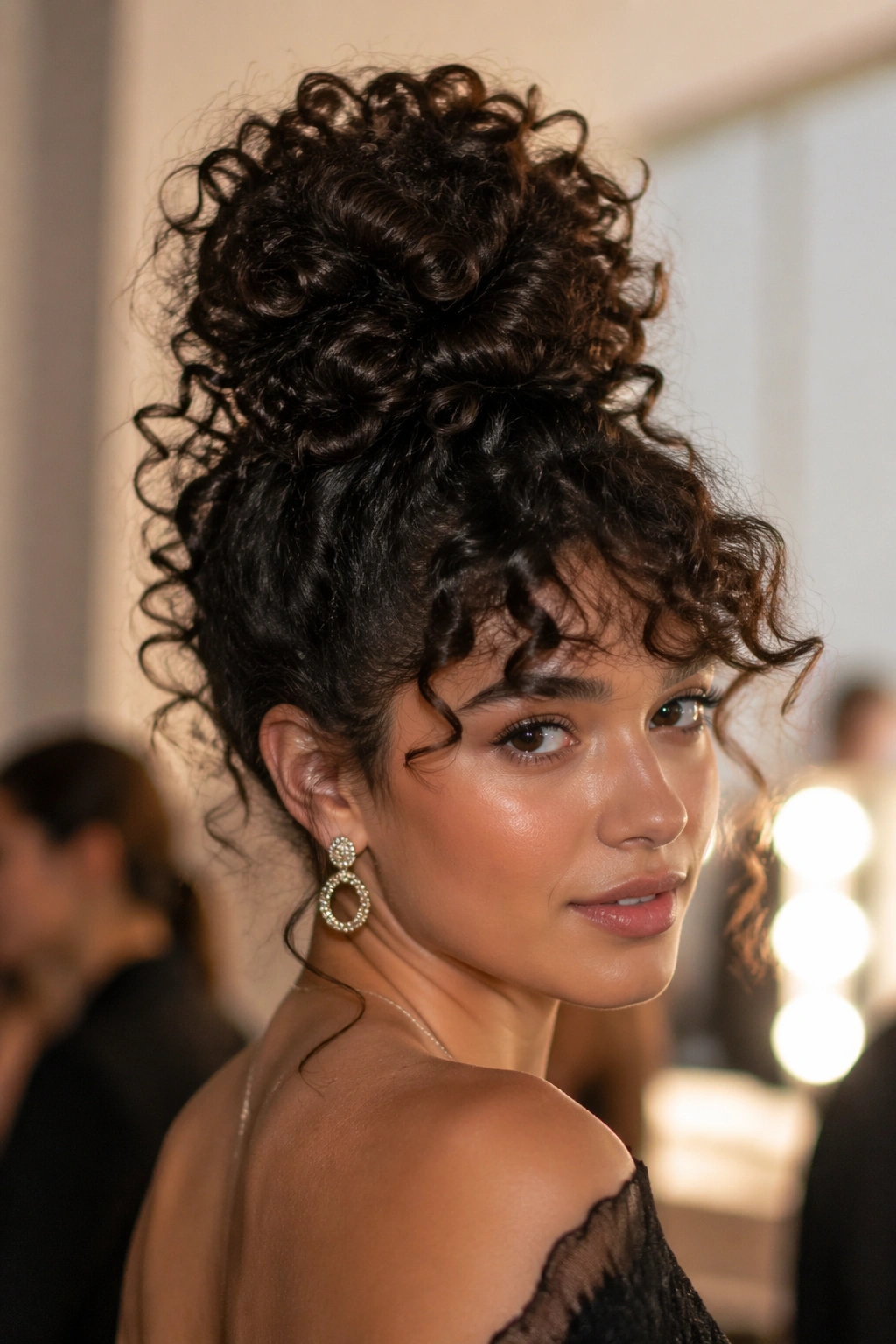 Portrait of a real person showing a voluminous top knot with curly ends