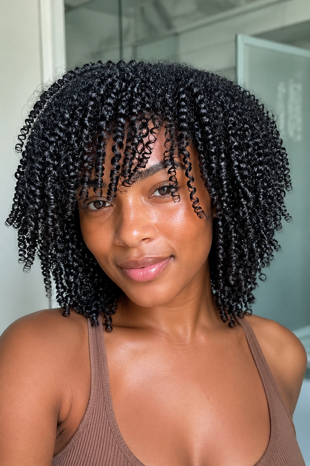Close-up of a real person with a polished wash-and-go curl pattern