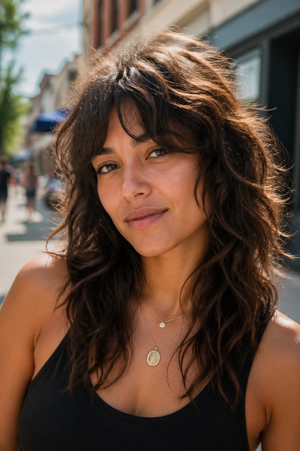 Close-up of a real woman with a wavy shag and curtain bangs on a sunny street