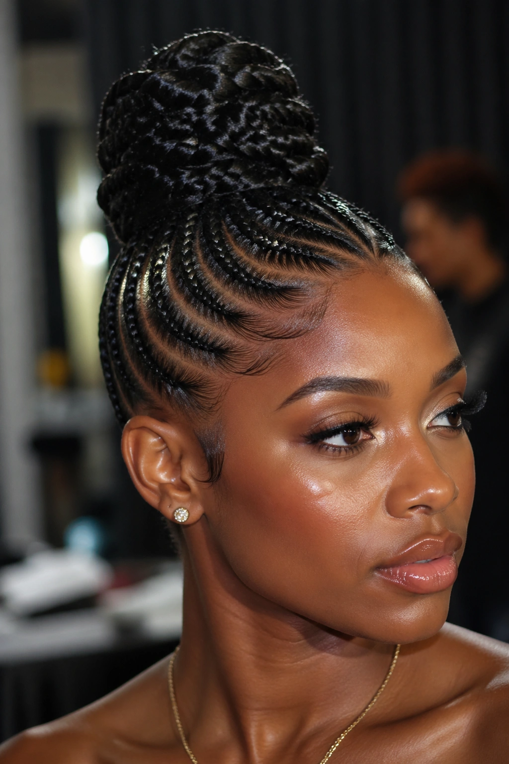 Close-up of real person with feed-in braids and a wet-look bun