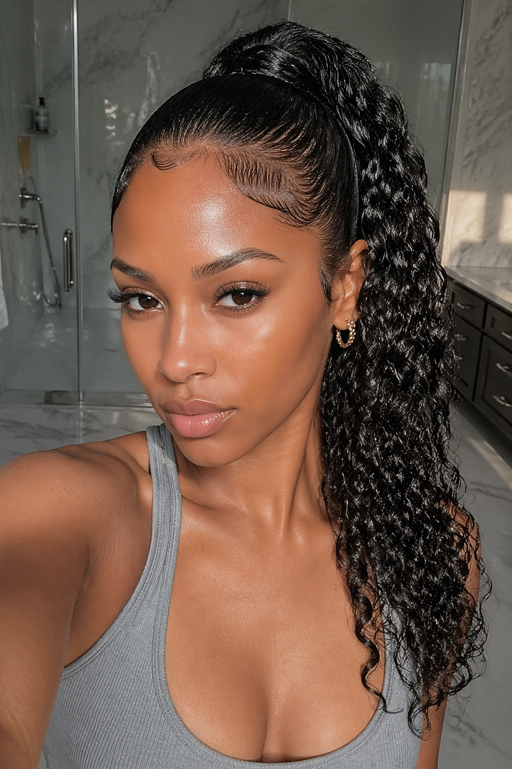 Close-up of a real woman with a wet-look curly ponytail and defined shine