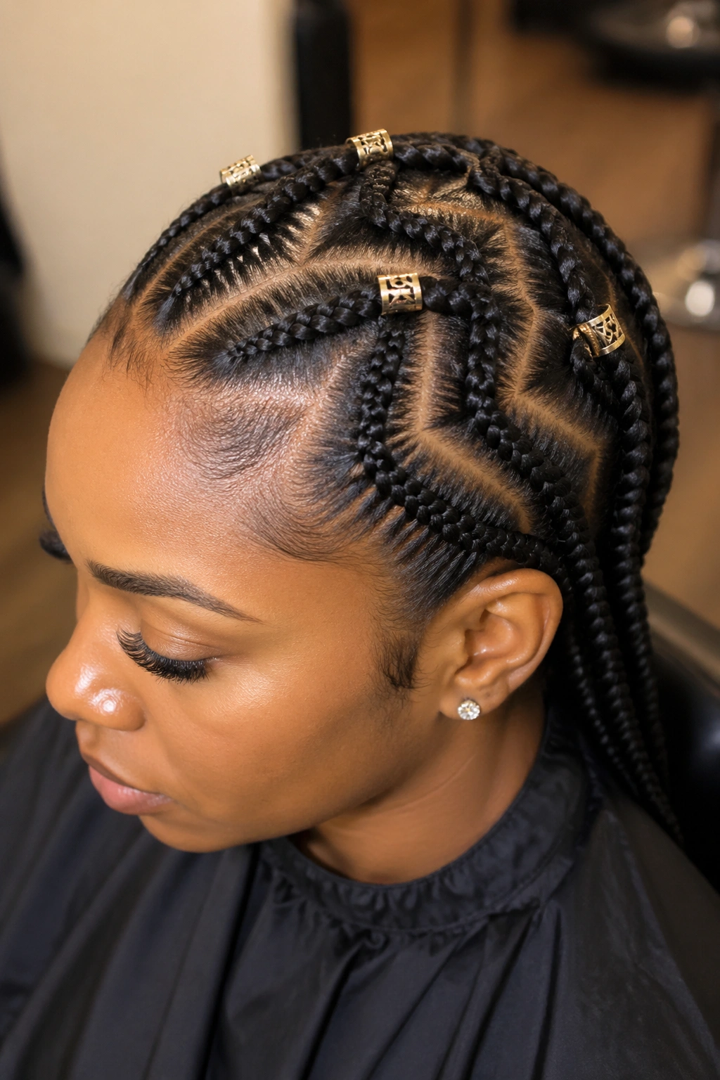 Close-up of a real woman with zigzag cornrows and metallic cuffs at the peaks